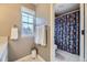 Bathroom with a large window for natural light, and a blue patterned shower curtain at 2522 W Dry Creek Ct, Littleton, CO 80120