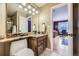 Bathroom featuring a granite countertop, updated fixtures, and a glimpse into an adjacent bedroom at 2522 W Dry Creek Ct, Littleton, CO 80120