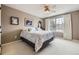 Bedroom with a queen-sized bed, a window with tree views, and neutral-toned walls at 2522 W Dry Creek Ct, Littleton, CO 80120