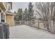 Large deck with wooden railing, great backyard view, and snow-covered evergreen trees at 2522 W Dry Creek Ct, Littleton, CO 80120