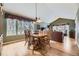 Sun-filled dining room with wood floors, large windows, and direct view into the cozy living room at 2522 W Dry Creek Ct, Littleton, CO 80120