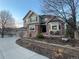 Landscaped two-story home with brick accents, bay window and three-car garage at 2522 W Dry Creek Ct, Littleton, CO 80120