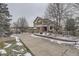 Charming two-story home with an attached two-car garage and mature trees on an overcast winter day at 2522 W Dry Creek Ct, Littleton, CO 80120