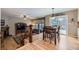 Open-concept living and dining area with hardwood floors and access to an outdoor deck, perfect for entertaining at 2522 W Dry Creek Ct, Littleton, CO 80120