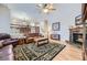 Open living room area with a fireplace, hardwood flooring, comfortable seating, and natural light at 2522 W Dry Creek Ct, Littleton, CO 80120