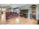 Inviting living room featuring hardwood floors, comfortable seating, and vintage piano at 2522 W Dry Creek Ct, Littleton, CO 80120