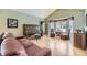 Cozy living room featuring a piano, comfortable seating, and large bay windows at 2522 W Dry Creek Ct, Littleton, CO 80120