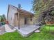 Charming back exterior featuring a covered patio and manicured lawn at 13385 Jasmine St, Thornton, CO 80602
