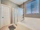 Bright bathroom with a soaking tub, glass-enclosed shower and a window for natural light at 13385 Jasmine St, Thornton, CO 80602