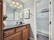 Stylish bathroom featuring a modern sink, a framed mirror and a shower room with glass door at 13385 Jasmine St, Thornton, CO 80602