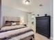 The bedroom features a queen-sized bed and dark wood dresser at 13385 Jasmine St, Thornton, CO 80602