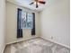 Bright bedroom with carpeted floors, a window with blinds and curtains, and a ceiling fan at 13385 Jasmine St, Thornton, CO 80602