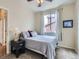 Bright bedroom featuring a comfortable bed, ceiling fan and large window providing natural light at 13385 Jasmine St, Thornton, CO 80602