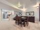 Open-concept dining area with hardwood floors, a dining table and a partial view of the kitchen at 13385 Jasmine St, Thornton, CO 80602