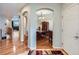 Charming entryway featuring arched doorways and hardwood floors leading to the dining room at 13385 Jasmine St, Thornton, CO 80602