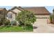 Charming home featuring a stone facade, manicured lawn and a mature front yard tree at 13385 Jasmine St, Thornton, CO 80602
