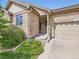 Beautiful front exterior featuring stone accents and a two-car garage at 13385 Jasmine St, Thornton, CO 80602