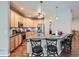 Open concept kitchen with wood floors, granite counters, stainless appliances, and counter seating at 13385 Jasmine St, Thornton, CO 80602