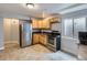 Efficient kitchen with stainless steel appliances, granite countertops, and modern cabinets at 13385 Jasmine St, Thornton, CO 80602