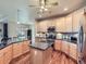 Spacious kitchen featuring wooden cabinets, granite countertops, and stainless steel appliances at 13385 Jasmine St, Thornton, CO 80602