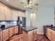 Bright kitchen featuring an island, stainless steel appliances, and hardwood flooring at 13385 Jasmine St, Thornton, CO 80602