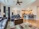 Open-concept living room with hardwood floors, tray ceiling, and a view of the kitchen at 13385 Jasmine St, Thornton, CO 80602
