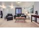 Cozy living room features a leather sofa, chair, rustic coffee table and modern lighting at 13385 Jasmine St, Thornton, CO 80602