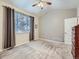 Bright bedroom featuring neutral decor, vaulted ceiling, and a large window at 13385 Jasmine St, Thornton, CO 80602