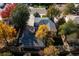 Overhead view of home with mature trees and fenced yard on a tree lined street in autumn at 5063 W 61St Ave, Arvada, CO 80003