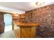 Finished basement bar area with brick accents, a wooden bar, and recessed lighting at 5063 W 61St Ave, Arvada, CO 80003