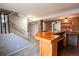 Basement wet bar has brick and wood design, with an opening to the kitchen and a staircase nearby at 5063 W 61St Ave, Arvada, CO 80003