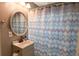 Cozy bathroom with decorative shower curtain, gray walls, and clean vanity at 5063 W 61St Ave, Arvada, CO 80003