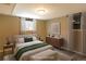 This bedroom offers natural light from two windows and is adorned with modern furniture and neutral tones at 5063 W 61St Ave, Arvada, CO 80003