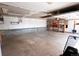 A spacious garage features a concrete floor and wall shelves for ample storage and organization at 5063 W 61St Ave, Arvada, CO 80003
