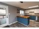 The kitchen offers plenty of storage and a breakfast bar with convenient access to the patio at 5063 W 61St Ave, Arvada, CO 80003