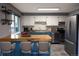Stylish kitchen featuring bright cabinets and an island with bar seating at 5063 W 61St Ave, Arvada, CO 80003