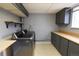 Functional laundry room with gray cabinets, a stainless steel washer and dryer, and ample counter space at 5063 W 61St Ave, Arvada, CO 80003