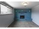 Inviting living room featuring a blue brick fireplace and a large window for natural light at 5063 W 61St Ave, Arvada, CO 80003