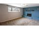 This living room features a decorative brick fireplace with a wooden mantle and a large window for ample natural light at 5063 W 61St Ave, Arvada, CO 80003