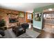Cozy living room showcases a brick fireplace, and an open dining area at 5063 W 61St Ave, Arvada, CO 80003