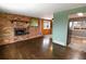 Comfortable living room features a brick fireplace, and adjoins an open dining area at 5063 W 61St Ave, Arvada, CO 80003