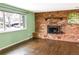 Bright living room with beautiful hardwood floors and a classic brick fireplace at 5063 W 61St Ave, Arvada, CO 80003