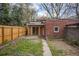 View of the backyard, including a detached garage and fenced yard at 652 N Gilpin St, Denver, CO 80218