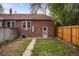 View of the backyard, featuring a detached garage and fenced yard at 652 N Gilpin St, Denver, CO 80218
