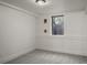 A carpeted bedroom with neutral walls, baseboard trim, and a window at 652 N Gilpin St, Denver, CO 80218