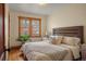 Comfortable bedroom with hardwood floors, a cozy bed, and a sunlit window at 652 N Gilpin St, Denver, CO 80218