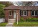 Charming brick home featuring a well-maintained front yard and tidy landscaping at 652 N Gilpin St, Denver, CO 80218