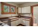 Cozy kitchen features wood frame cabinets, black tile countertop and an exterior view window at 652 N Gilpin St, Denver, CO 80218