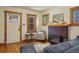Relaxing living space with a brick fireplace, hardwood floors, and a comfortable seating arrangement at 652 N Gilpin St, Denver, CO 80218