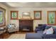 Inviting living room boasts a brick fireplace, wood trim windows, and comfortable seating at 652 N Gilpin St, Denver, CO 80218